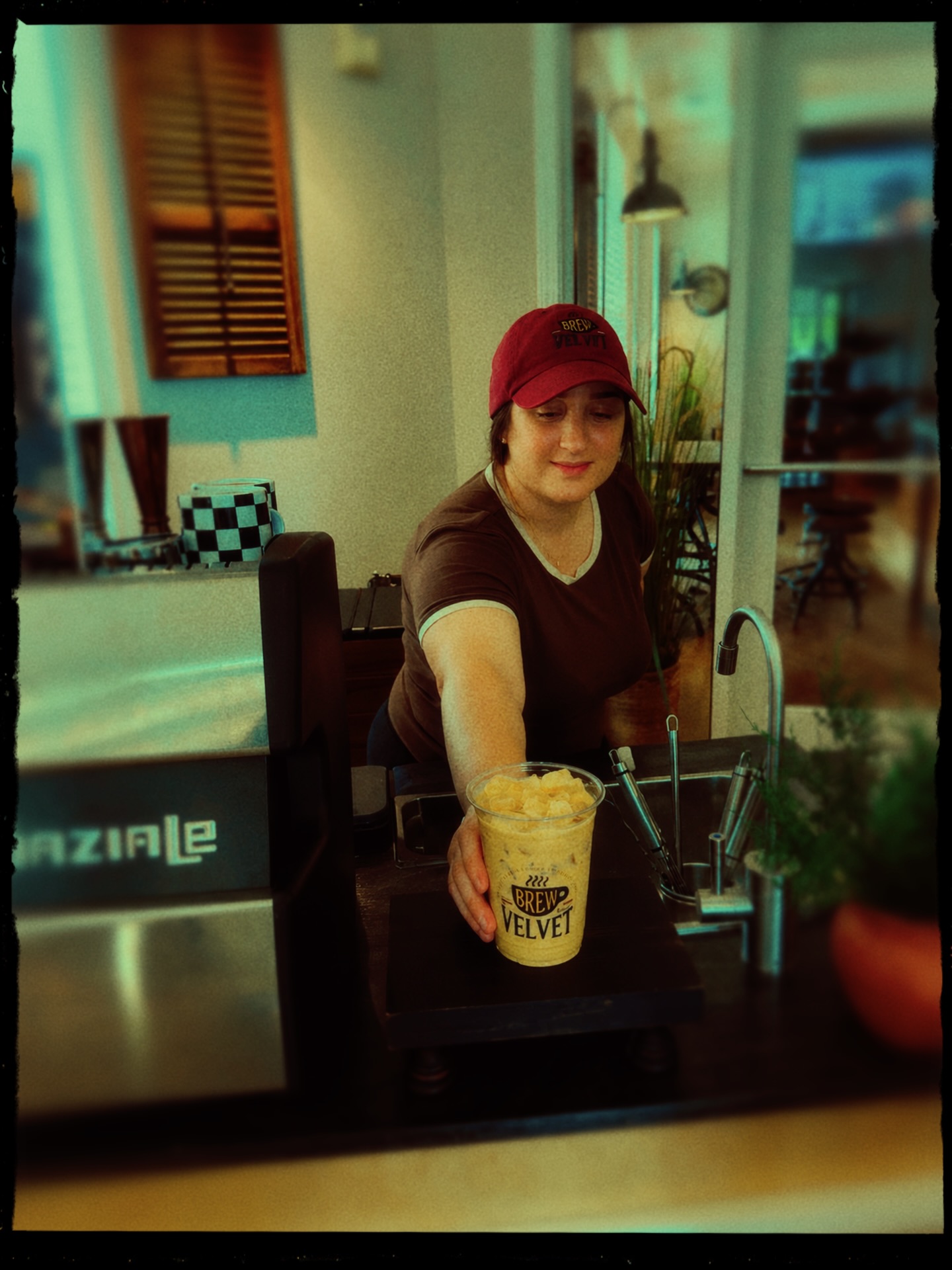 Alexis serving an iced coffee at the Brew Velvet cart
